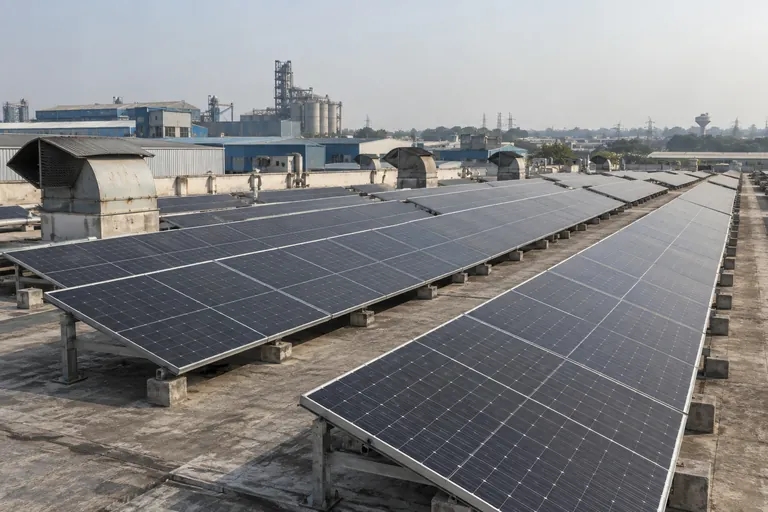 Architectural 3D illustration of a solar array with access aisles on a Haryana factory roof
