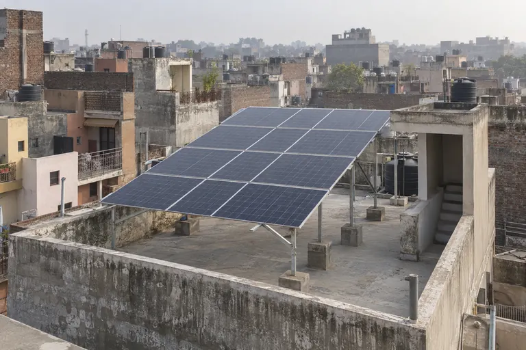 Architectural 3D illustration of solar racks above mixed-use Old Delhi terraces